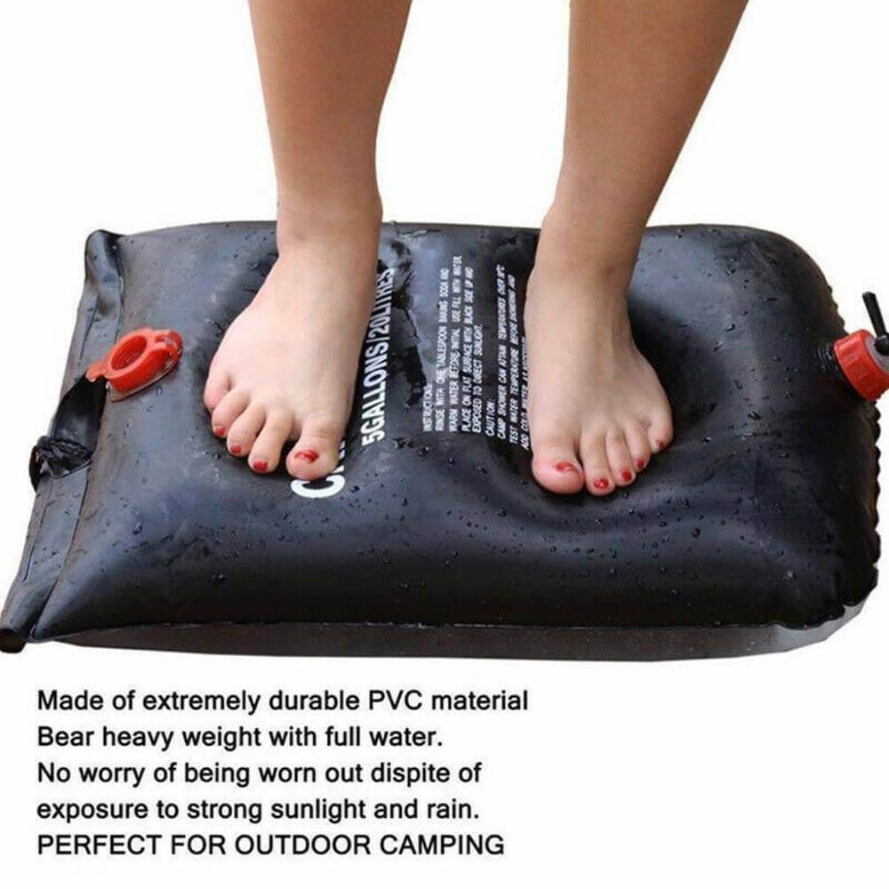 Someone standing on the portable camping shower bag displaying its durability and ability to support heavy weight.