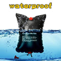 The portable camping shower half submerged in water displaying its waterproof functionality.