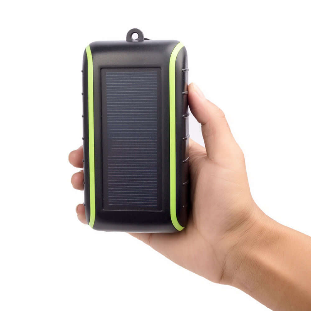 Someone holding a the solar power bank charger.